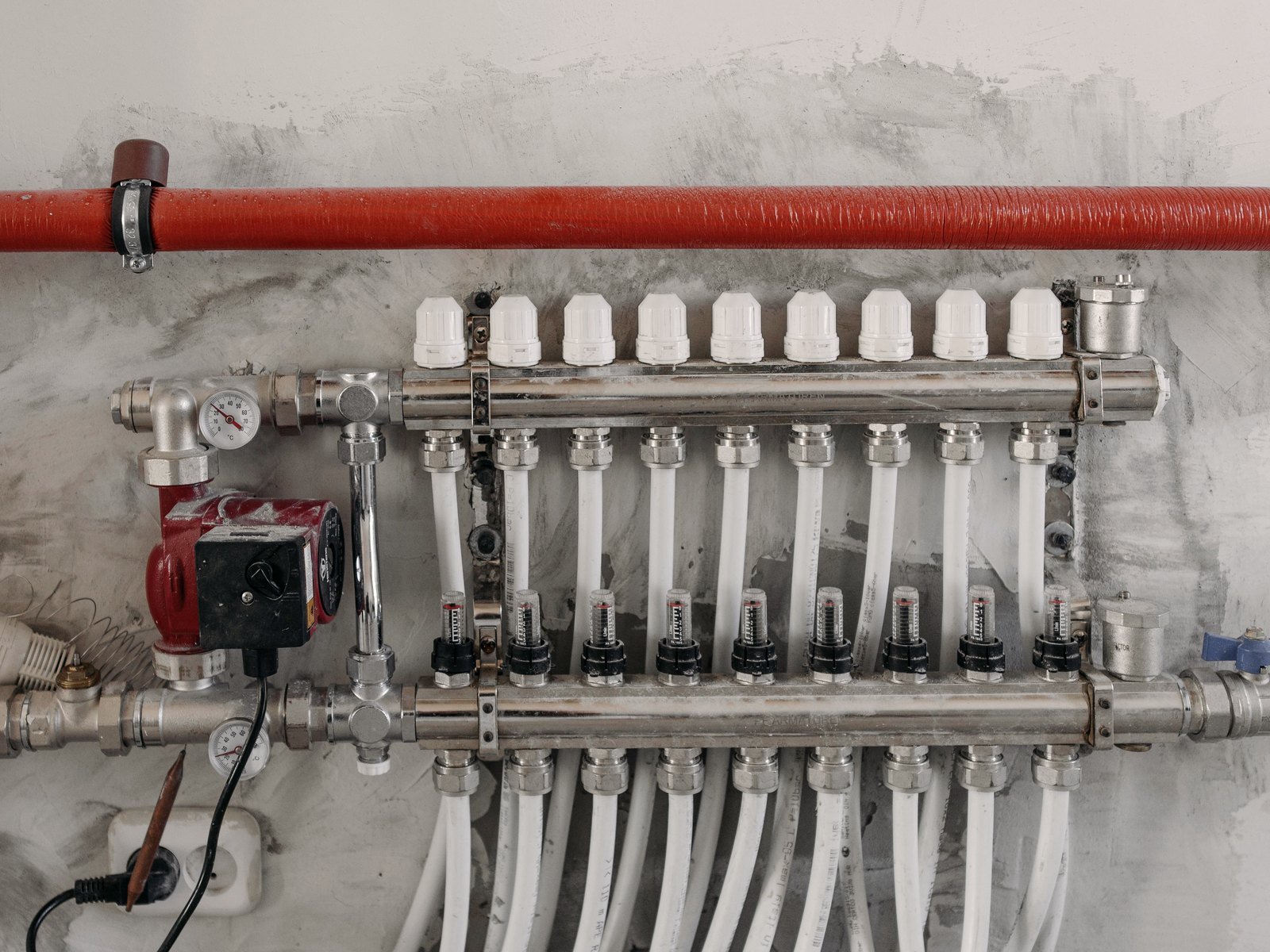 Industrial heating manifold with pressure gauges and steel pipework