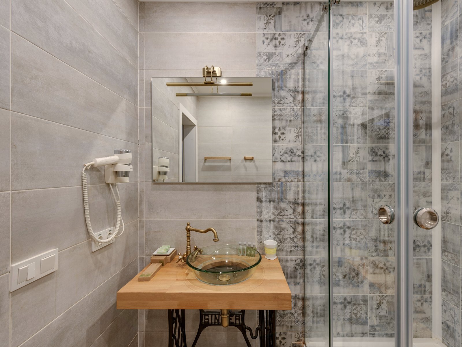 Modern residential bathroom with a glass shower and basin