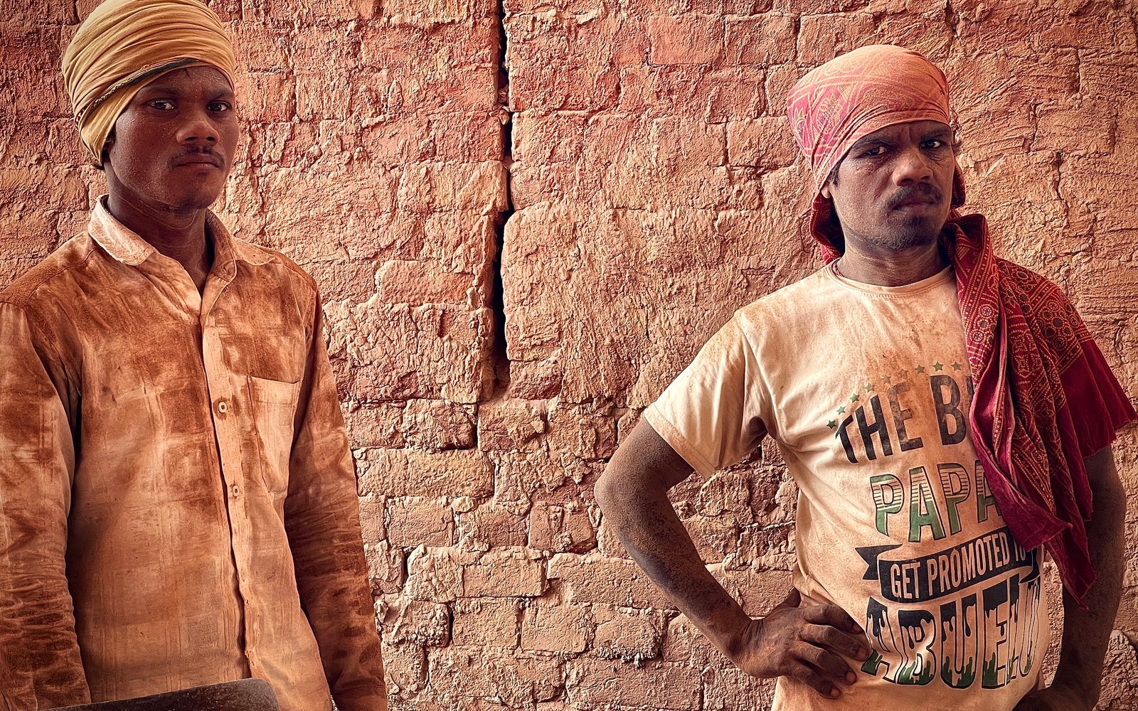 Two tradespeople in workwear standing together